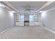 Cozy basement room featuring built-in shelves, a ceiling fan and carpet flooring at 3871 River Mansion Dr, Peachtree Corners, GA 30096