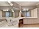 Bathroom vanity featuring white cabinets, double sinks, and mirrors at 3871 River Mansion Dr, Peachtree Corners, GA 30096
