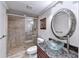 Modern bathroom features glass shower, granite counters, vessel sink, and decorative mirror at 3871 River Mansion Dr, Peachtree Corners, GA 30096