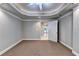 Spacious bedroom with doorway to tiled room and back door, illuminated by ceiling fan at 3871 River Mansion Dr, Peachtree Corners, GA 30096