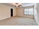 Bedroom features a ceiling fan and large window, creating a bright and comfortable retreat at 3871 River Mansion Dr, Peachtree Corners, GA 30096