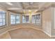 Bright bedroom featuring bay windows, a ceiling fan, coffered ceilings, and neutral carpeting at 3871 River Mansion Dr, Peachtree Corners, GA 30096