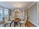 This dining area offers a neutral palette with hardwood floors and a modern light fixture, ideal for intimate gatherings at 3871 River Mansion Dr, Peachtree Corners, GA 30096