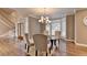 Formal dining area displays elegant staircase, hardwood floors, and natural light through white plantation shutters at 3871 River Mansion Dr, Peachtree Corners, GA 30096