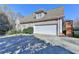 Stucco home with attached garage and driveway, nestled among trees and landscaping at 3871 River Mansion Dr, Peachtree Corners, GA 30096
