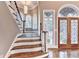 Grand foyer with hardwood floors, stairs, and decorative glass windows, offering a warm welcome at 3871 River Mansion Dr, Peachtree Corners, GA 30096