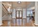 Grand foyer featuring arched windows, stained-glass doors, staircase and hardwood flooring at 3871 River Mansion Dr, Peachtree Corners, GA 30096