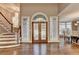 Elegant foyer with stained glass entryway, chandelier, hardwood floors, and staircase at 3871 River Mansion Dr, Peachtree Corners, GA 30096