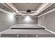 Carpeted home theater room with raised seating area and projector. Speaker system installed at 3871 River Mansion Dr, Peachtree Corners, GA 30096