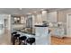 Bright kitchen with a curved island, stainless steel appliances, and access to a connected living space at 3871 River Mansion Dr, Peachtree Corners, GA 30096