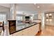 Gourmet kitchen with an island and seamless flow into the adjacent living spaces at 3871 River Mansion Dr, Peachtree Corners, GA 30096