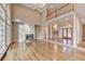 Bright and open living room featuring a fireplace, hardwood floors, and access to the foyer at 3871 River Mansion Dr, Peachtree Corners, GA 30096