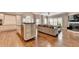 Bright and spacious living area featuring hardwood floors, a fireplace, and seamless flow into the modern kitchen at 3871 River Mansion Dr, Peachtree Corners, GA 30096
