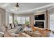 Inviting living room features hardwood floors, fireplace, and abundant natural light, creating a warm atmosphere at 3871 River Mansion Dr, Peachtree Corners, GA 30096