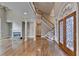 Spacious living room with hardwood floors, fireplace, columns, and staircase at 3871 River Mansion Dr, Peachtree Corners, GA 30096