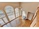 Spacious living room with hardwood floors, a fireplace, and large windows, filled with natural light at 3871 River Mansion Dr, Peachtree Corners, GA 30096