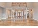 Open-concept living room featuring high ceilings, hardwood floors, and an upstairs balcony at 3871 River Mansion Dr, Peachtree Corners, GA 30096