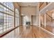 Open living room with fireplace, tall windows, hardwood floors, and staircase to the second floor at 3871 River Mansion Dr, Peachtree Corners, GA 30096