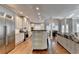 Spacious living area offers a modern kitchen, hardwood floors, and ample natural light, great for entertaining at 3871 River Mansion Dr, Peachtree Corners, GA 30096