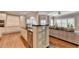 Open-concept living space combines kitchen and living areas with hardwood floors and contemporary decor at 3871 River Mansion Dr, Peachtree Corners, GA 30096