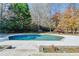 Private pool surrounded by mature trees and landscaping, offering a serene and tranquil outdoor space for enjoyment at 3871 River Mansion Dr, Peachtree Corners, GA 30096