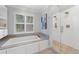 Spa-like bathroom featuring a soaking tub and a separate glass-enclosed shower at 4250 Green Ridge Ne Dr, Marietta, GA 30062