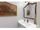 Charming powder room boasting a decorative mirror and framed artwork at 4250 Green Ridge Ne Dr, Marietta, GA 30062