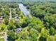 Aerial view of the home's location near a lake surrounded by dense trees and lush green landscape at 2945 Cardinal Lake Cir, Duluth, GA 30096