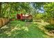 Spacious backyard featuring a red home with a deck, surrounded by a wooden fence at 2945 Cardinal Lake Cir, Duluth, GA 30096