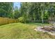 Lush green backyard with mature trees and partial fence, offering privacy and space at 2945 Cardinal Lake Cir, Duluth, GA 30096