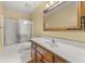 Bathroom with sliding glass door shower and wooden vanity at 2945 Cardinal Lake Cir, Duluth, GA 30096