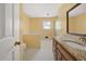Spacious yellow bathroom features a large mirror and a separate tub and shower at 2945 Cardinal Lake Cir, Duluth, GA 30096
