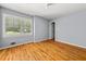 Sunlit bedroom featuring hardwood floors and plantation shutters on a window at 2945 Cardinal Lake Cir, Duluth, GA 30096