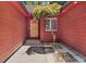 A home entryway with an arched wood door, small tree, and textured concrete pathway at 2945 Cardinal Lake Cir, Duluth, GA 30096