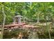 Relaxing gazebo on a wooden platform surrounded by lush trees, perfect for enjoying nature at 2945 Cardinal Lake Cir, Duluth, GA 30096