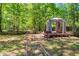 Wooded backyard features a gazebo with curtains, creating a peaceful outdoor space at 2945 Cardinal Lake Cir, Duluth, GA 30096