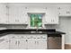 Galley style kitchen features stainless steel appliances and white cabinets with dark countertops at 2945 Cardinal Lake Cir, Duluth, GA 30096