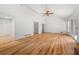 A spacious living room with hardwood floors, a ceiling fan, and sliding glass doors at 2945 Cardinal Lake Cir, Duluth, GA 30096