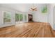 Bright living room featuring hardwood floors, a brick fireplace, and large windows at 2945 Cardinal Lake Cir, Duluth, GA 30096
