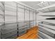 Walk-in closet with multiple shelves and sections for optimal organization at 2945 Cardinal Lake Cir, Duluth, GA 30096