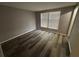 Bedroom features wood-look flooring and bright natural light through a window at 6353 Wedgeview Ct, Tucker, GA 30084