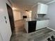 Galley kitchen features granite counters, ample storage, and is open to the living area at 6353 Wedgeview Ct, Tucker, GA 30084