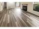 Bright living room featuring hardwood floors, fireplace, and sliding glass doors to outdoor space at 6353 Wedgeview Ct, Tucker, GA 30084