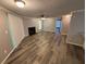 Open-concept living room boasts wood-look floors, a cozy fireplace, and bright natural light at 6353 Wedgeview Ct, Tucker, GA 30084