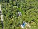 Aerial view displays home in a secluded location surrounded by dense trees and greenery at 4200 E 166 Hwy, Carrollton, GA 30116