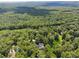 Expansive aerial view of the property surrounded by a dense forest, creating a private retreat at 4200 E 166 Hwy, Carrollton, GA 30116