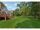 Expansive backyard with lush lawn, mature trees, deck, and patio at 4200 E 166 Hwy, Carrollton, GA 30116