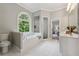 Well-lit bathroom with a soaking tub, separate shower, and large window at 4200 E 166 Hwy, Carrollton, GA 30116