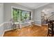 Light-filled dining area with large window, hardwood floors, and stylish seating at 4200 E 166 Hwy, Carrollton, GA 30116