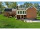 Rear exterior view of a brick home, featuring a large backyard and patio at 4200 E 166 Hwy, Carrollton, GA 30116